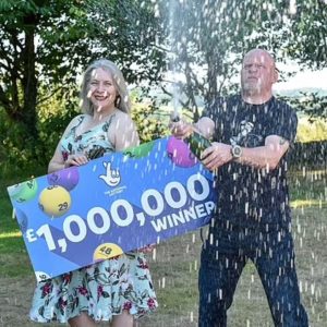 Couple shows lottery winnings with champagne